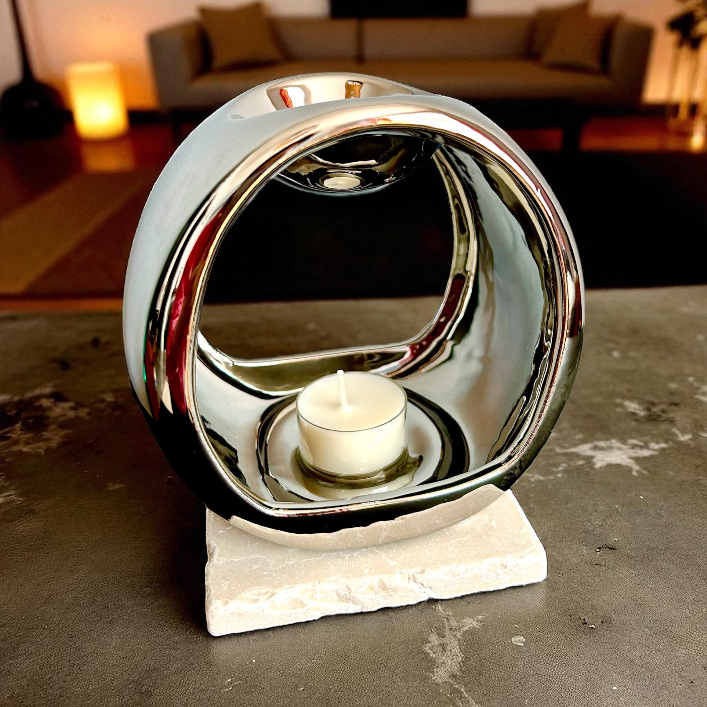 Hearth Halo Wax Burner — Chrome Finish with a rounded open centre and unlit tealight on a white square slab.